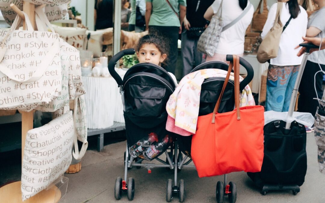 baby in stroller near people standing