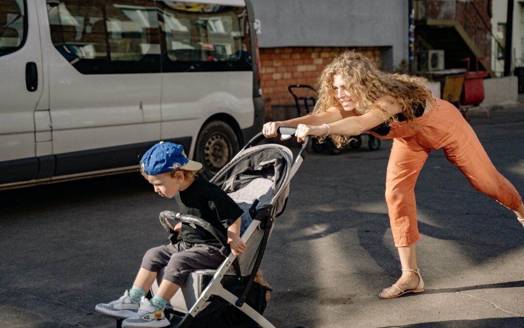 Mother Pushing Stroller with Son Through Stree